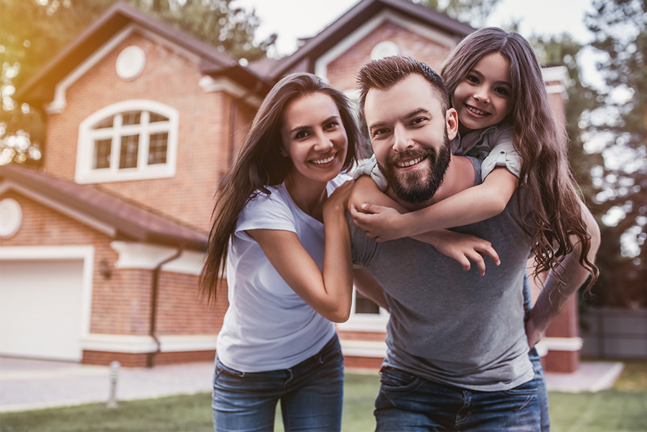family in front of home