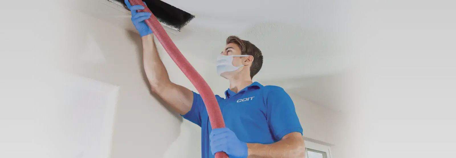 technician cleaning an air duct