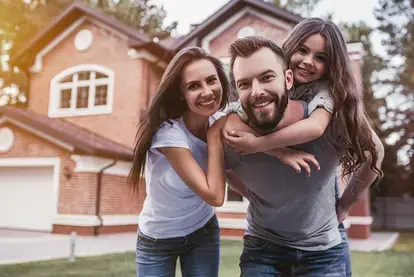 family in front of home