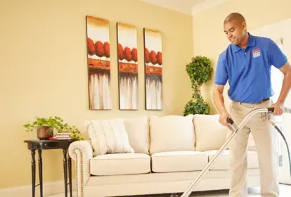 technician cleaning living room carpet