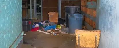 squatter's belongings sitting inside a room