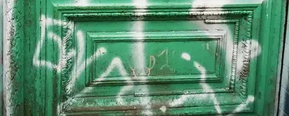 graffiti spay painted onto a green door