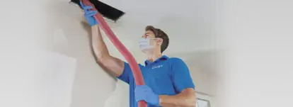 technician cleaning air duct