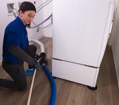 technician cleaning a dryer vent