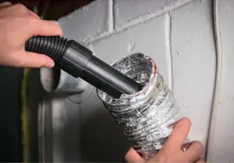 technician cleaning a dryer vent