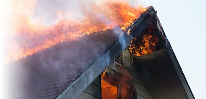Fire engulfs the roof of a home.