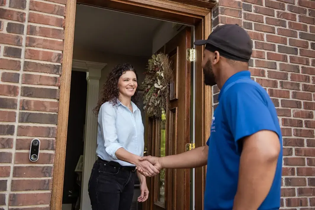 Technician shaking customer's hand